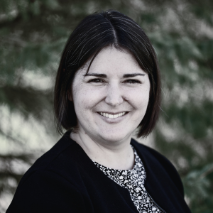 Black & white headshot of Katie Corker, Executive Director at ASAPbio and author of this piece.